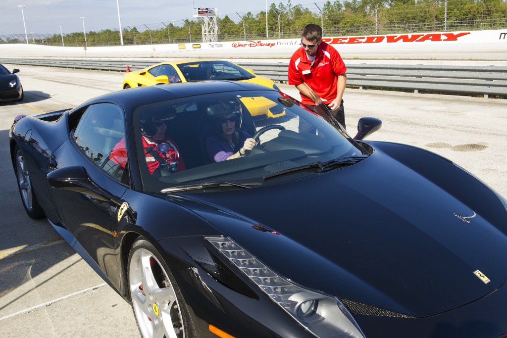 Richard Petty Driving Experience - Pit crew loading a guest into the Ferrari
